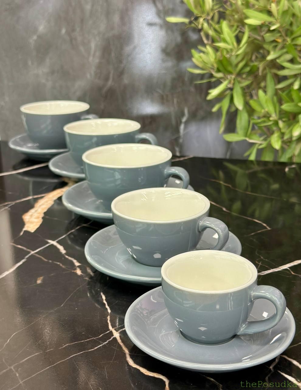Hands holding a warm ceramic cup of black coffee