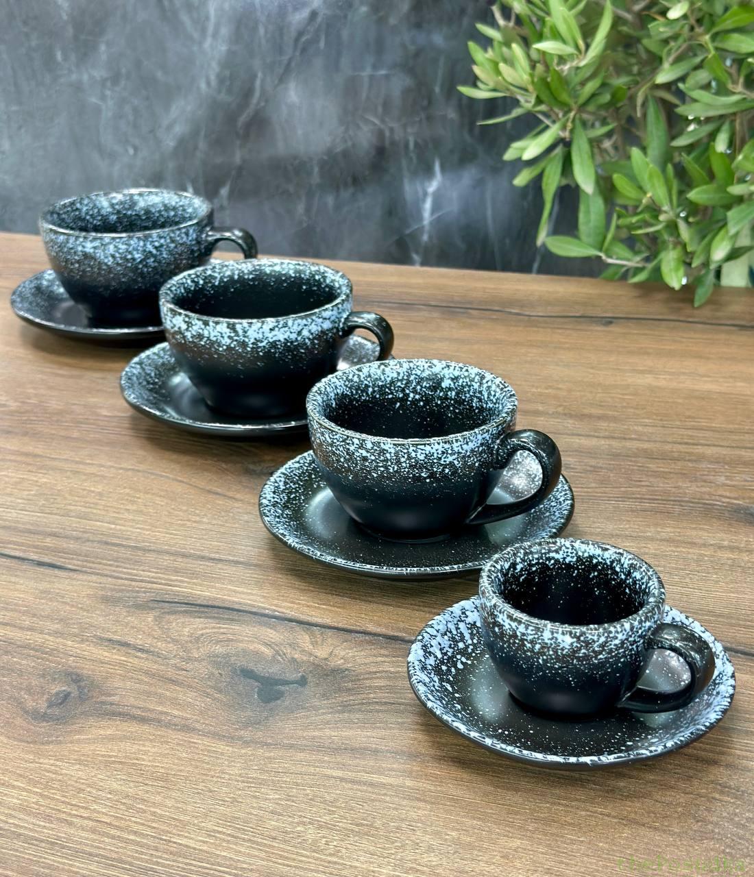 Teal and grey glossy cappuccino cups on matching saucers