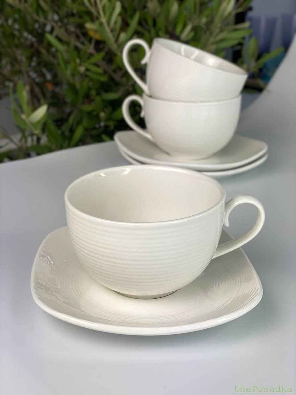 White ribbed porcelain cups on square saucers