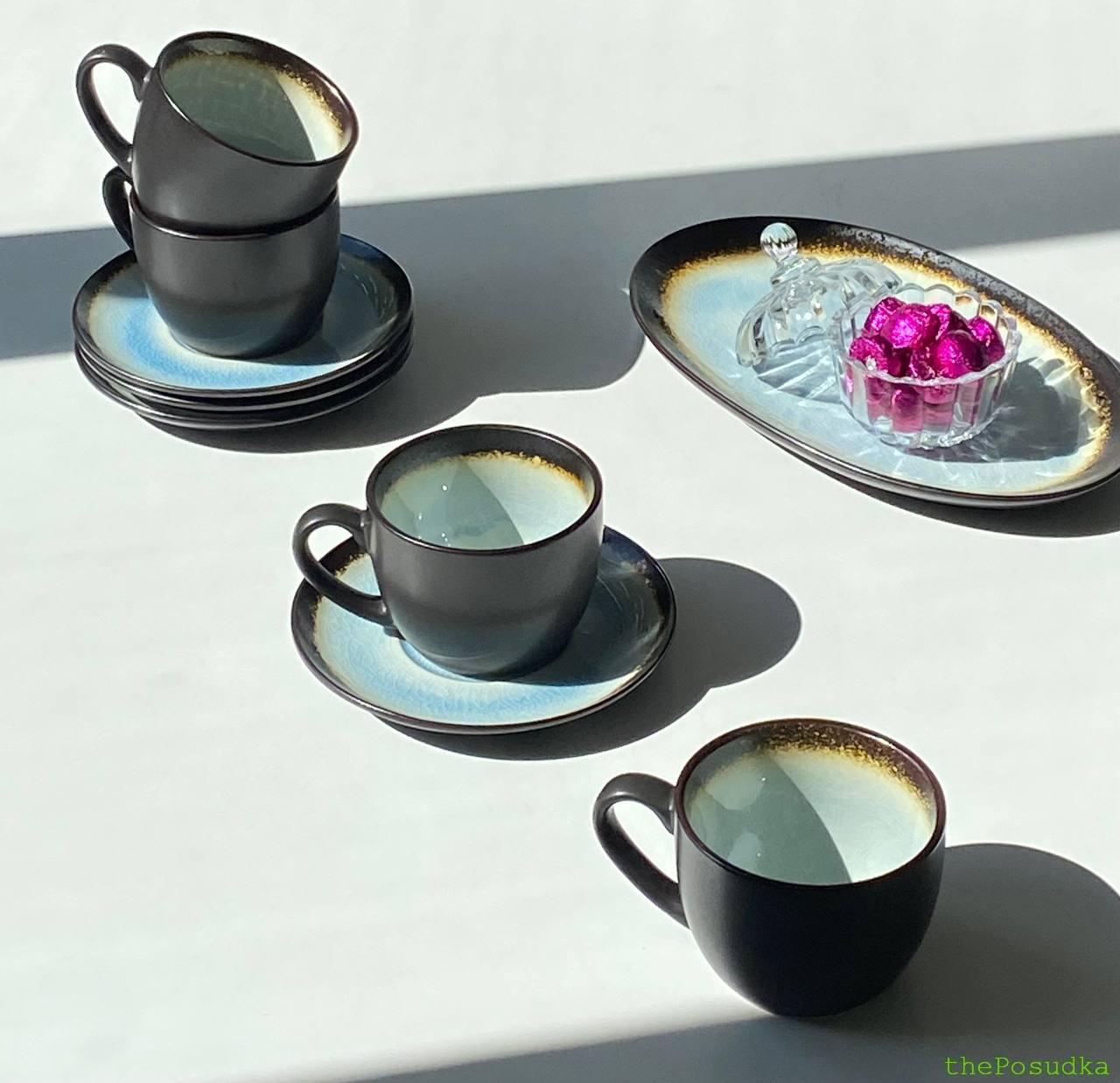 Cream cups with warm brown speckled rims on matching saucers
